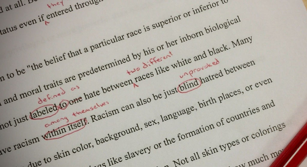 A written paper marked up in red ink.