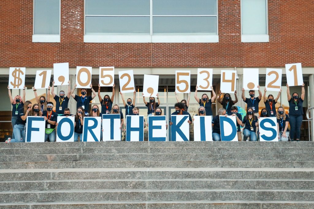 HuskyTHON students holding up the dollar amount raised this year.