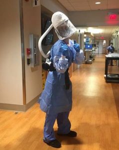 Technical analyst William Banker in full personal protective equipment on a hospital floor