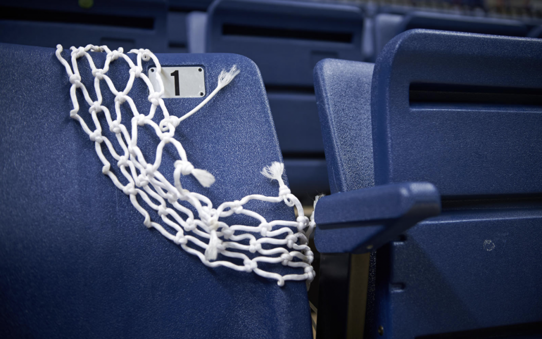A net cut from a basketball hoop draped over a seat in Gampel Pavilion, as UConn's two basketball teams prepare for the NCAA tournament.