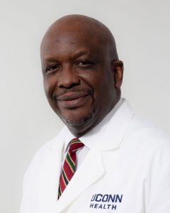 Dr. HIlary Onyiuke white coat portrait