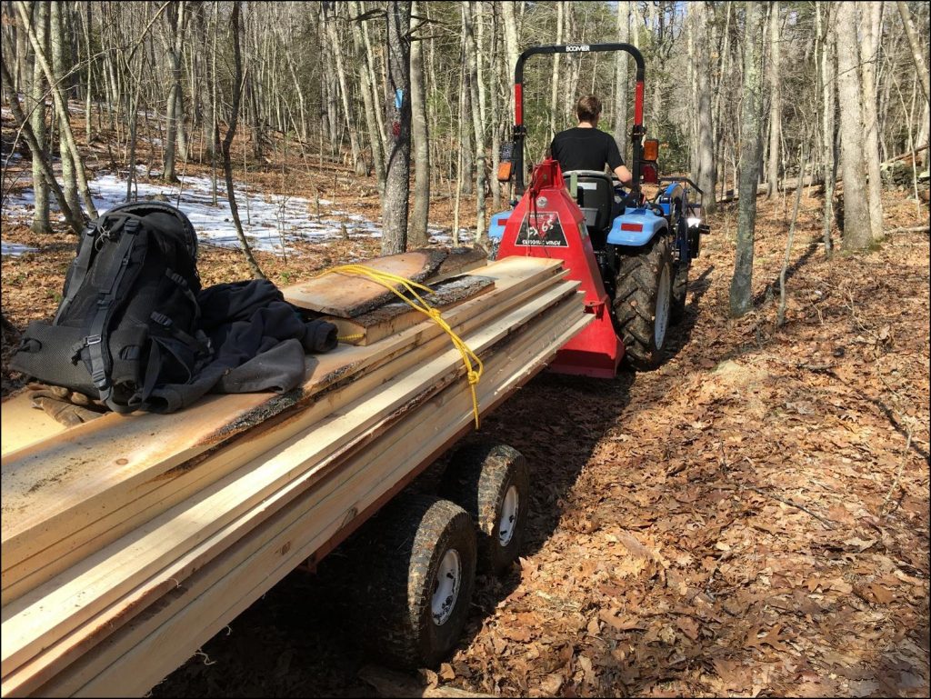 UConn Forestry crew hauling pine boards out of the forest