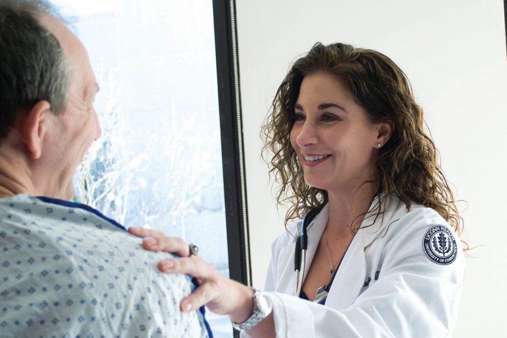 Dr. Rebecca Andrews interacting with patient pre-COVID