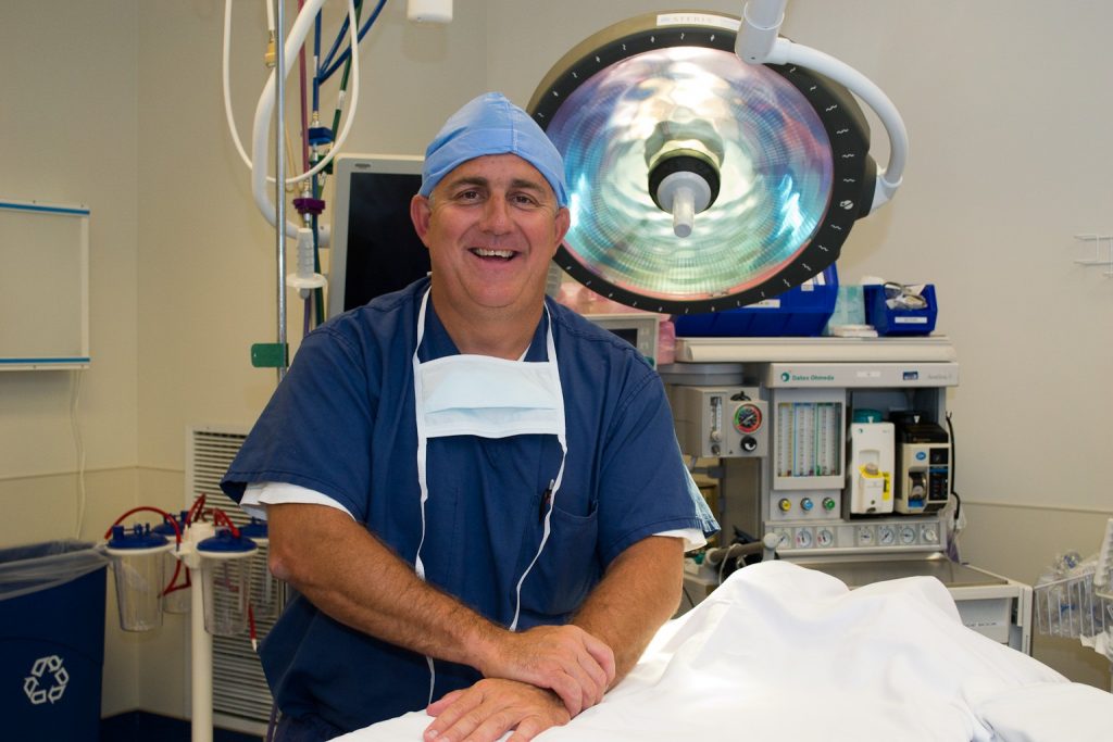 Dr. Gus Mazzocca in his scrubs, in a UConn Health operating room.