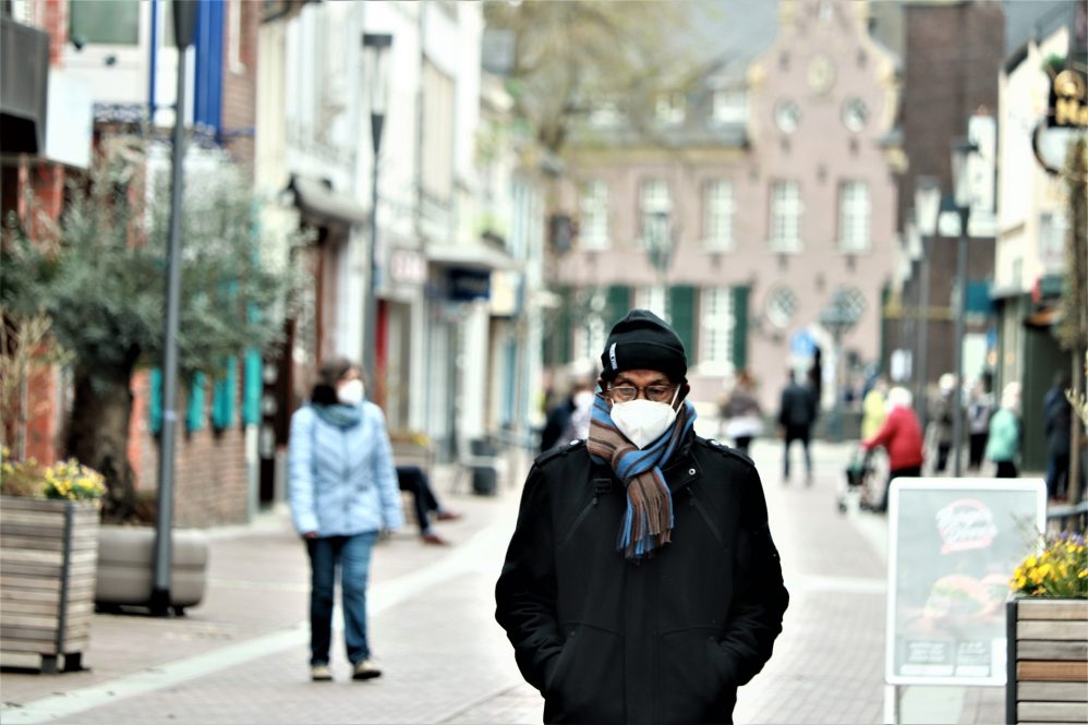 Man walking down the street wearing a face mask
