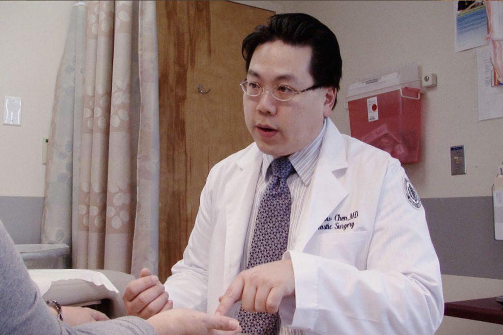 Dr. Andrew Chen with a patient in an exam room