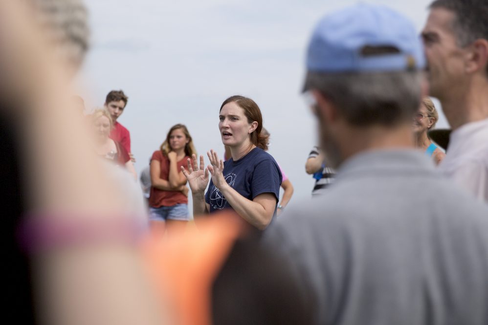 Associate Professor of Physics Cara Battersby talks to attendees at a solar eclipse viewing on Horsebarn Hill in 2017. Her work uses high-performance computing to understand astronomical questions