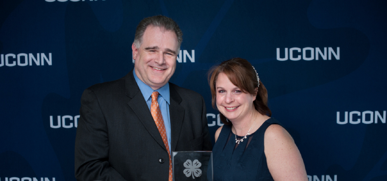 Rachael Manzer, with her husband Ken, receives a 4-H leadership award in 2019. Manzer, a STEM educator who has worked with NASA, is a doctoral candidate in the Neag School of Education. (Courtesy of Defining Studios)