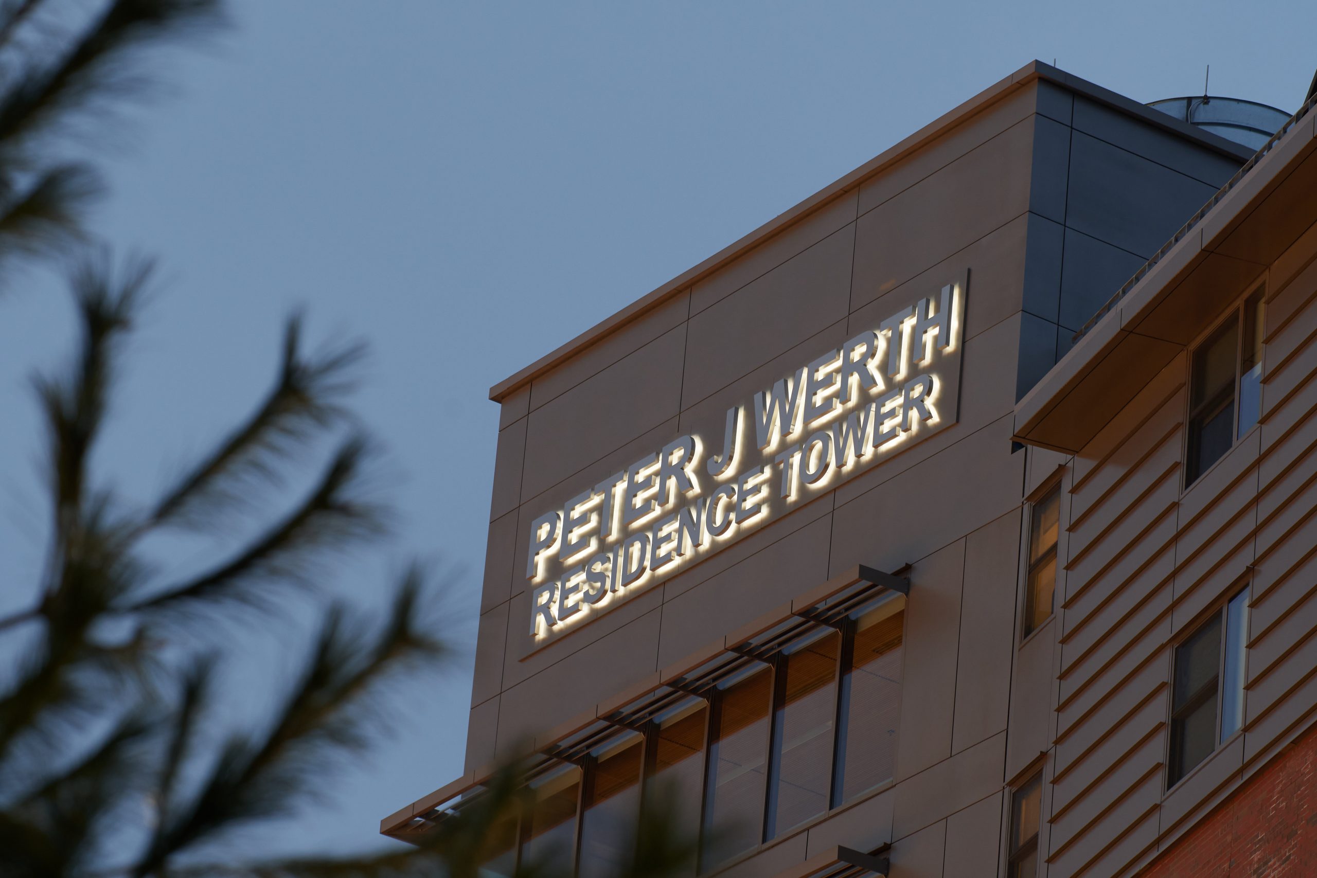 The exterior of the Werth Tower building at dusk.