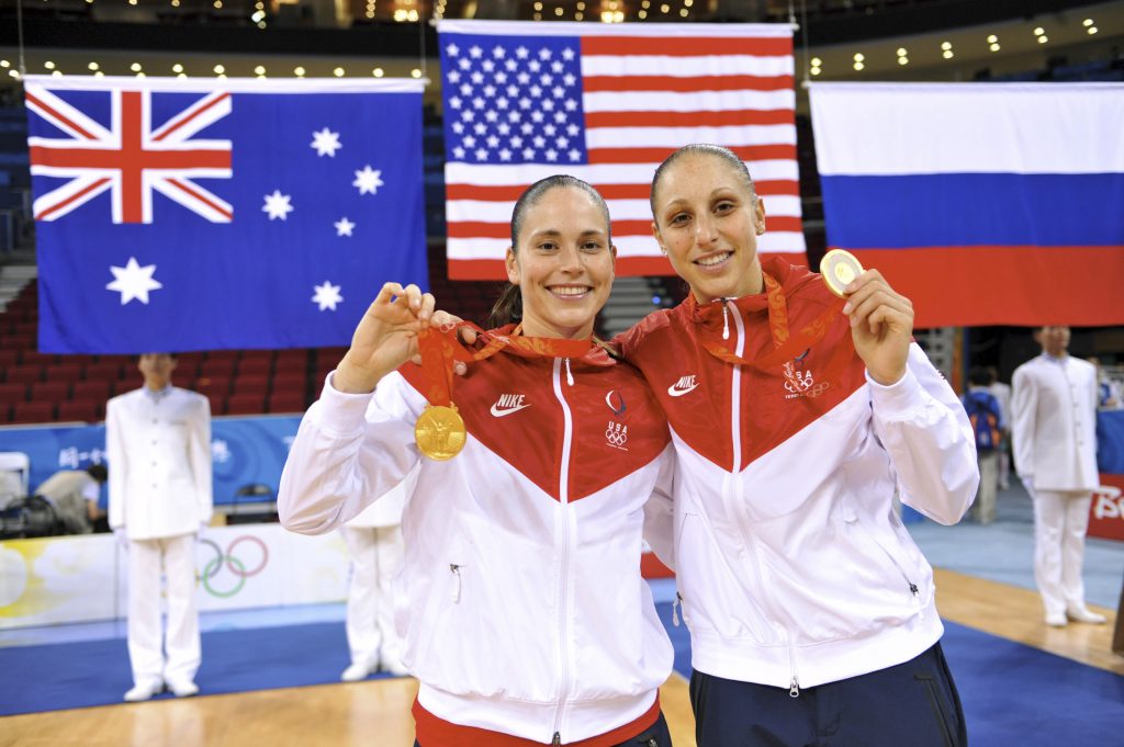 UConn alumnae Sue Bird (left) and Diana Taurasi, shown here with the gold medals they won at the Beijing 2008 Olympic Games, will again represent the USA in the summer games, this year in Tokyo.