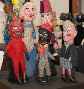 Punch and Judy hand puppets created by Fred Kneeland in the 1920s includes a Black minstrel figure, reflecting the immense popularity of minstrel shows.
