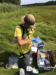 Aiden Barry '19 (CAHNR) sampling soil for microbial analysis in the field.