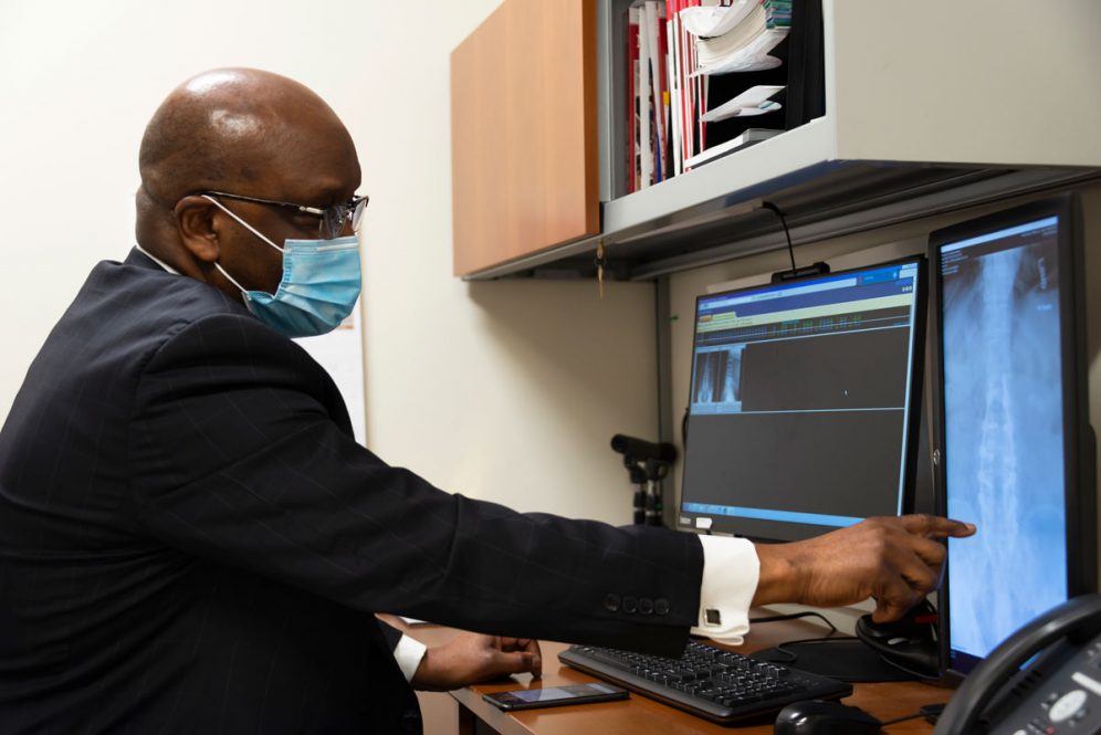 Dr. Hilary Onyiuke looking at spine image
