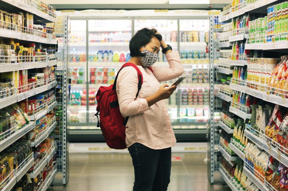 woman standing in a grocery store isle