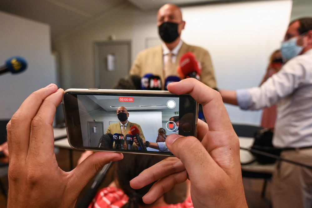 A photo of a news conference being livestreamed via iPhone. As the tools and delivery platforms of journalism have changed, fundamental skills remain critical, says UConn journalism department head Marie Shanahan.