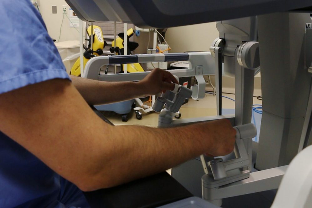 Image of surgoen manipulating robotic surgical tools
