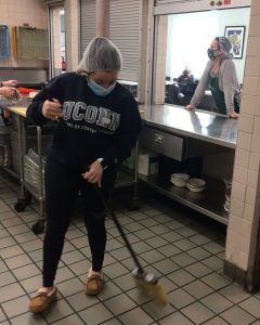 Natalia Hernandez sweeping floor in food pantry