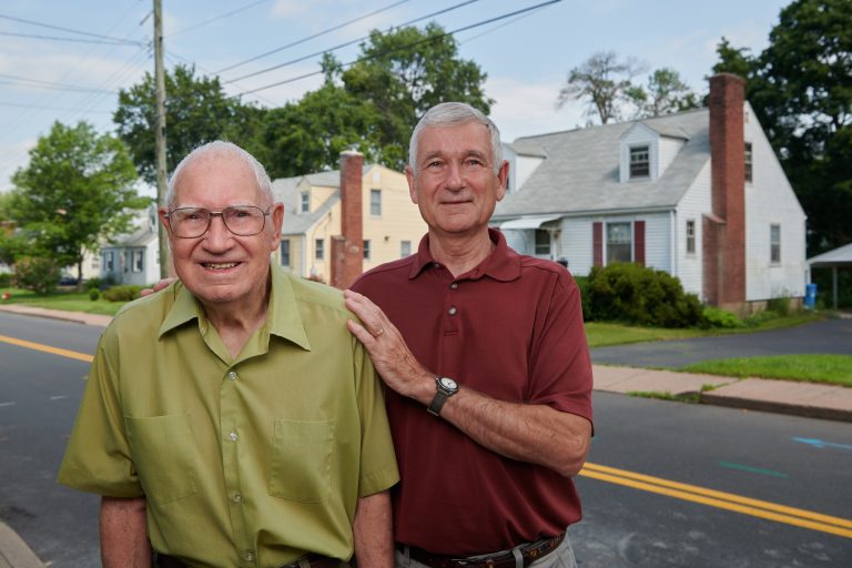 Fredrick Ware, left, and his son, David Ware JD '76, LLM '20 stand in front of his home in Manchester on July 17, 2021.