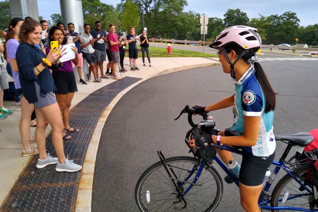 Crowd greets June Chu as she arrives on her bicycle at academic entrance