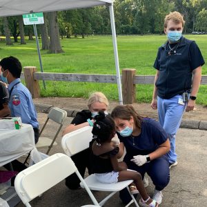 patient care at outdoor community clinic