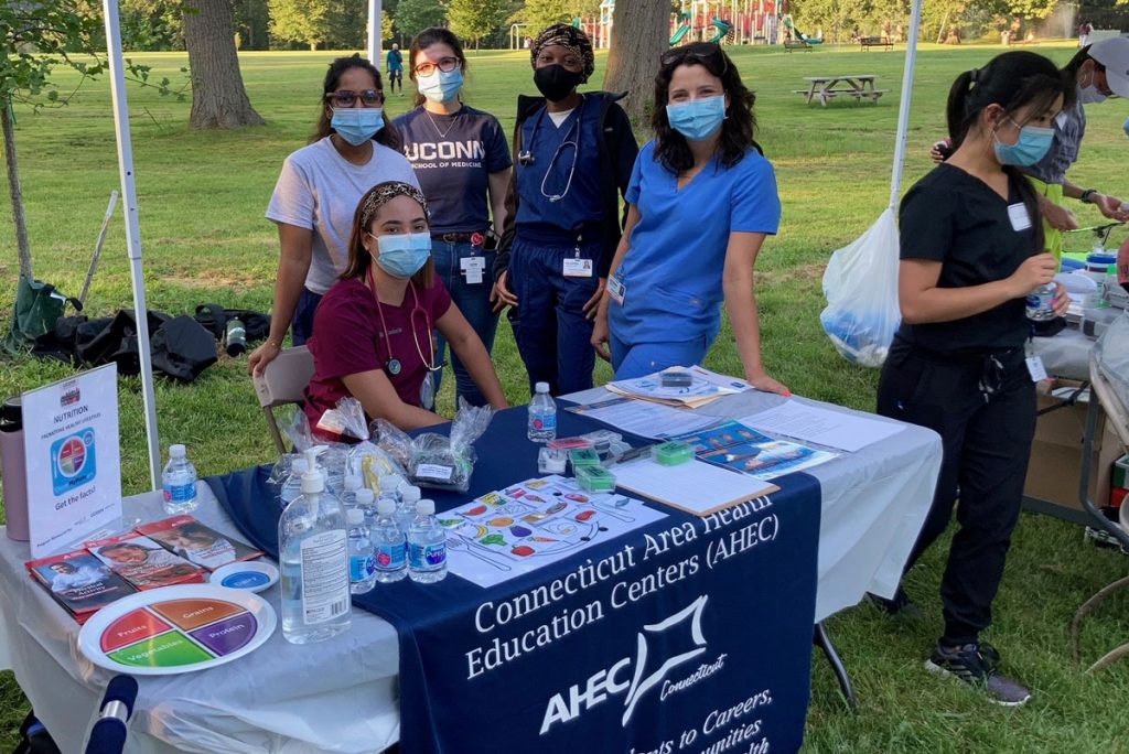 Volunteers at a commnity health clinic, check-in table in a park