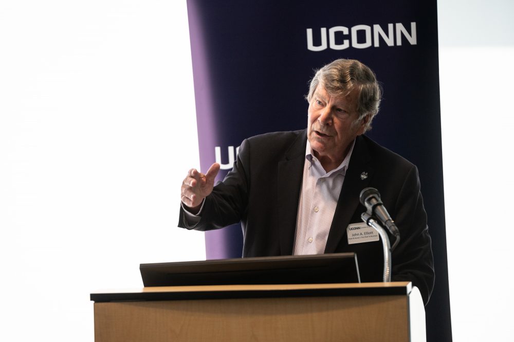 UConn School of Business Dean John Elliott speaking at a news conference in Hartford announcing a $2 million federal grant to assist minority-owned small businesses in Connecticut.