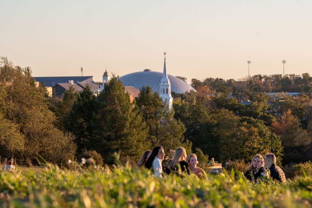 Students on Horsebarn Hill with campus skyline in background on October 8, 2020. (Sean Flynn/UConn photo)