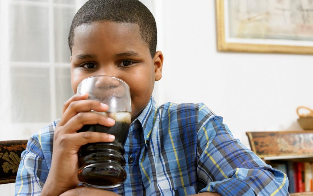 Kid drinking a cola drink
