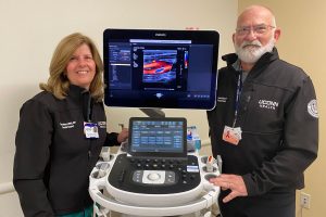 Two vascular technologists with advanced ultrasound machine
