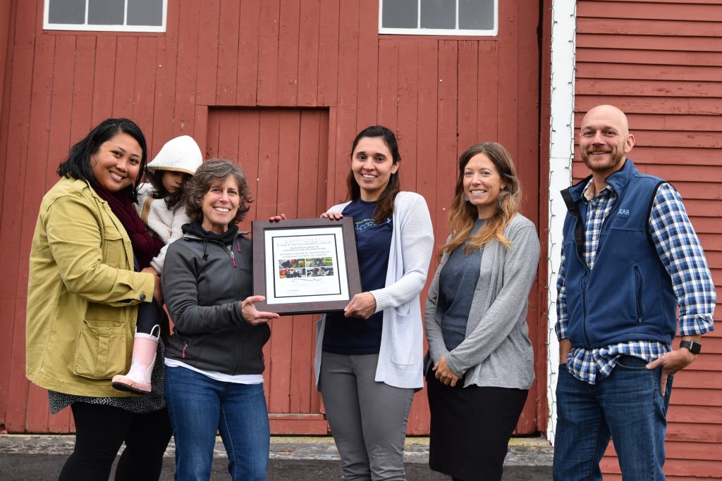 Group photo in front of red barn