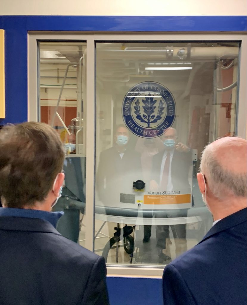 Gov. Ned Lamont and Jeffrey Hoch, director of the Gregory P. Mullen NMR Structural Biology Facility at UConn Health, on a tour of research facilities at the Farmington campus.