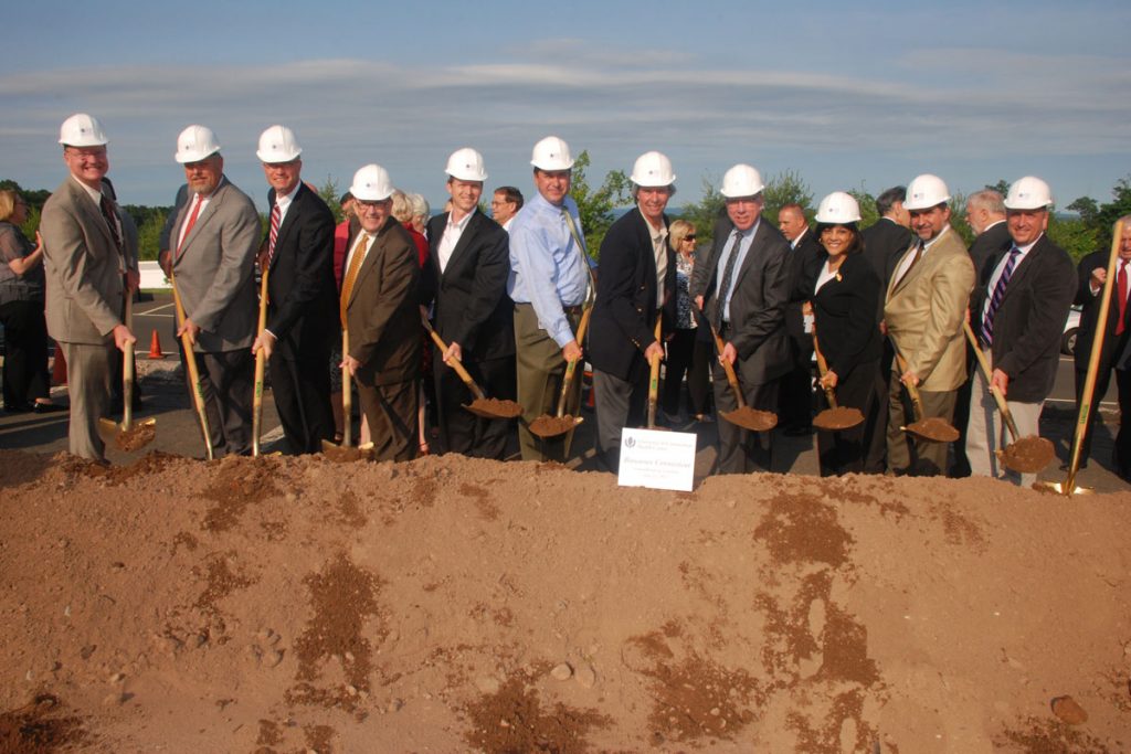 Group in hardhats with shovels at groundbreaking ceremony