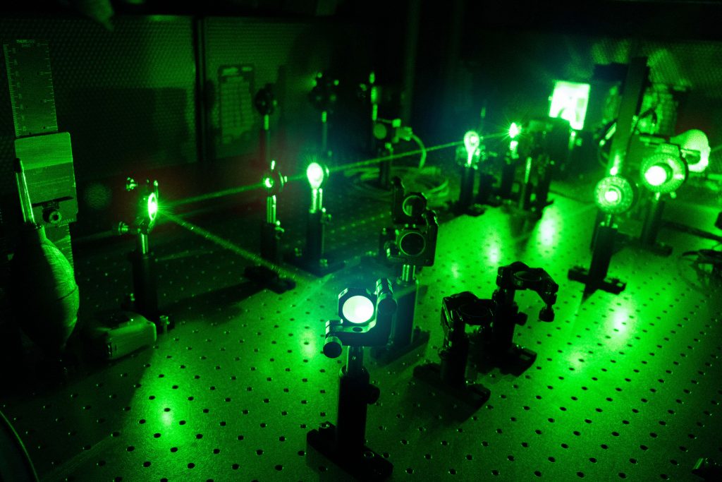 A small green laser beams off a series of receptors.