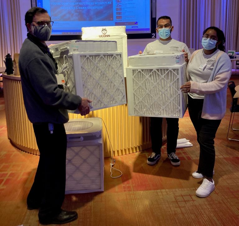 UConn School of Medicine Associate Dean of Primary Care Bruce Gould, along with School of Medicine students Harrison Dieuveuil '25 and Samhita Gurrala '25 with Corsi-Rosenthal boxes.