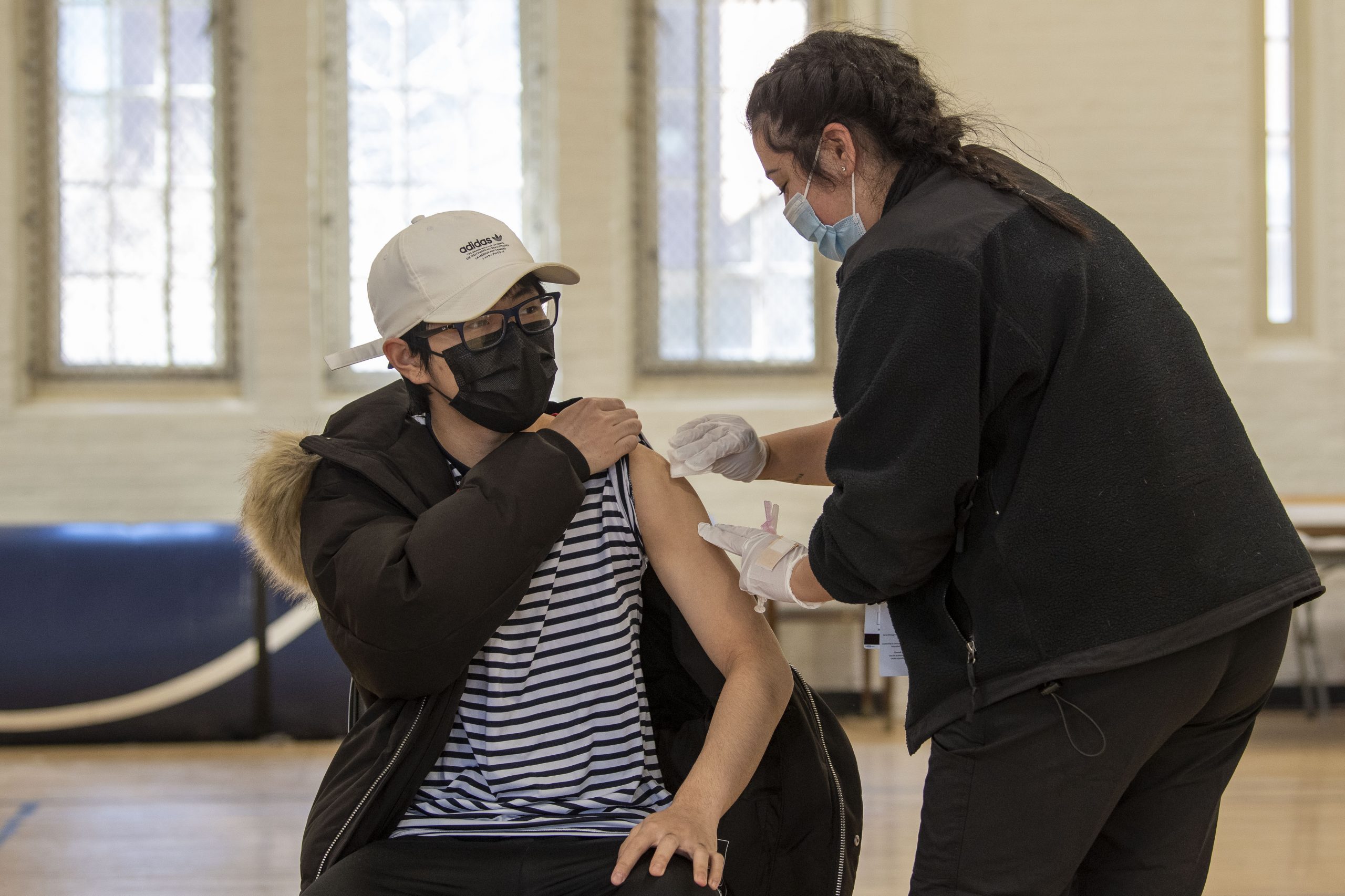 Students receiving the COVID 19 vaccine at Hawley Armory on April 8, 2021. The rollout of the vaccines across the state in the spring helped set up a return to a more familiar university experience. (Sean Flynn/UConn Photo)