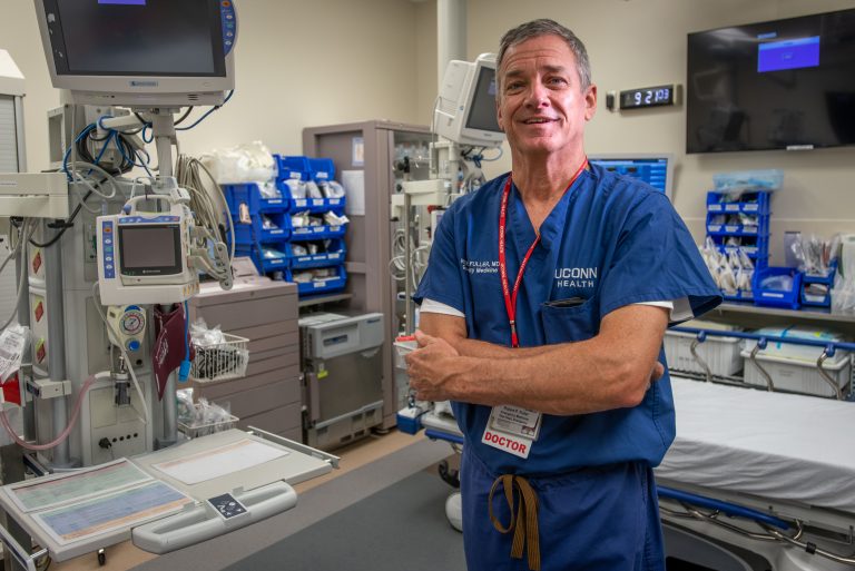 Dr. Robert Fuller in blue scrubs in the emergency department