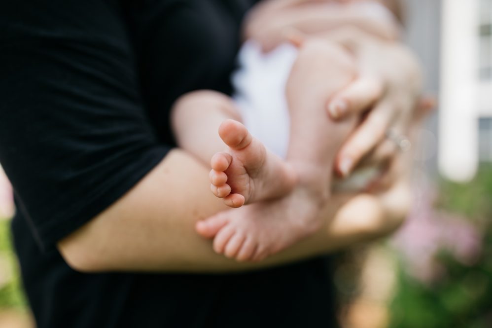 A woman holds a baby