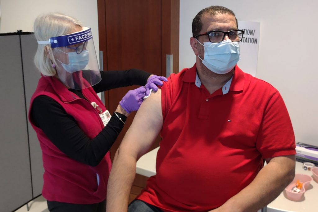 Nurse bandages a patient after shoulder injection