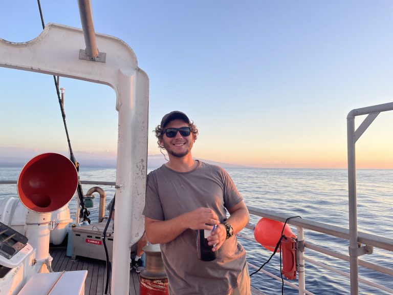 Carson Hill ’21 (CLAS), on the quarterdeck at the rear of the ship at sunset. The island of Maui is behind me. (Photo courtesy of Sea Education Association | SEA Semester ®)