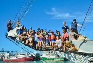 The ship's company, standing on the bowsprit at the end of the voyage. The total group onboard included 20 students, 4 scientists, 3 mates, 2 engineers, 2 deckhands, 2 stewards, and a captain. (Photo courtesy of Sea Education Association | SEA Semester ®)