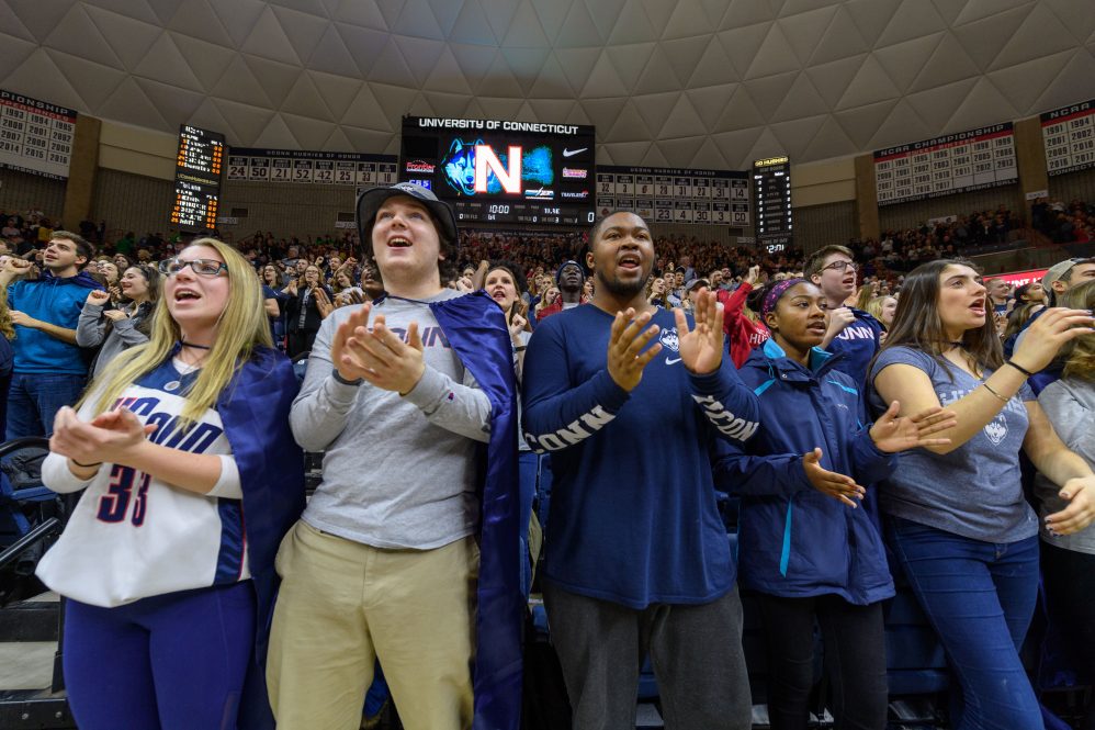 UConn fans cheering on a basketball team at Gampel Pavilion in Storrs.