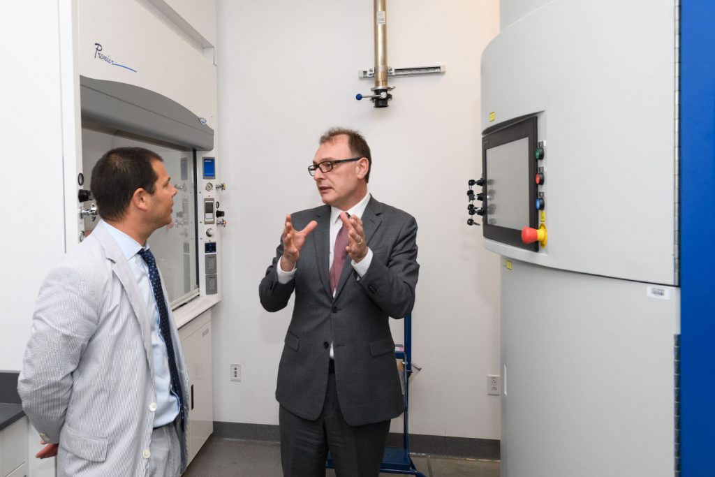 Dr. Pamir Alpay discussing technology within IPB Building on UConn campus