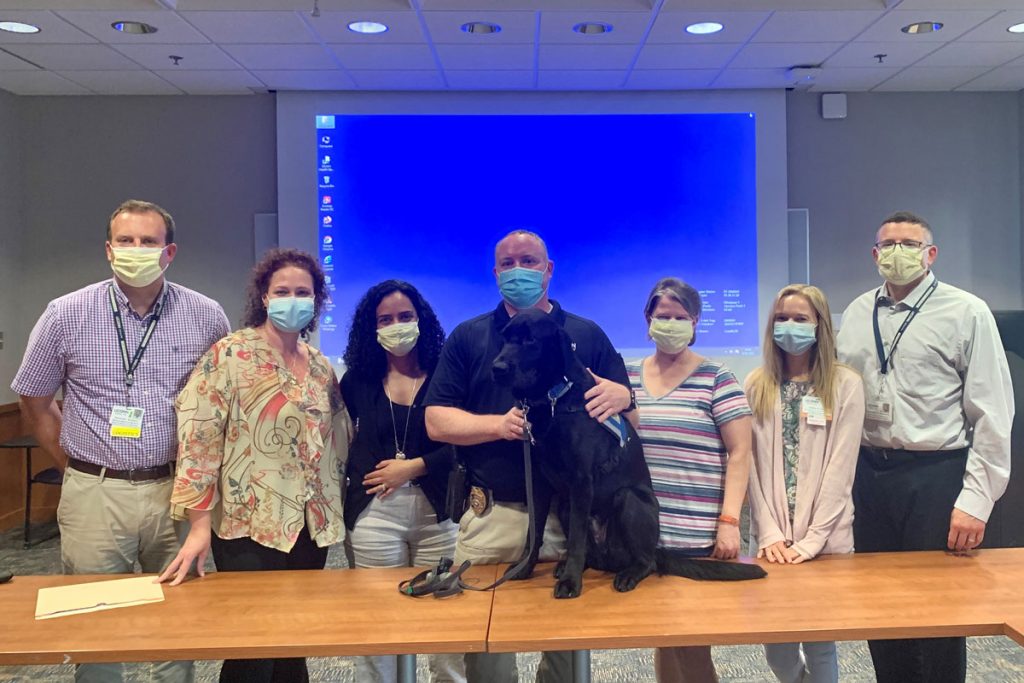 Group portrait with UConn police dog in training room