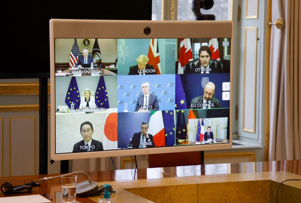 A picture taken on February 24, 2022 shows (from Up, L) US President Joe Biden, Britain's Prime Minister Boris Johnson, Canadian Prime Minister Justin Trudeau, European Commission President Ursula von der Leyen, NATO Secretary General Jens Stoltenberg, President of the European Council Charles Michel, Japan's Prime Minister Fumio Kishida, Prime Minister Mario Draghi and French President Emmanuel Macron during a video-conference of G7 leaders on Ukraine at the Elysee Palace in Paris. - Russia has launched an invasion of Ukraine in the early hours of February 24, 2022, defying Western outrage and global appeals not to launch a war. (Photo by Ludovic MARIN / POOL / AFP).