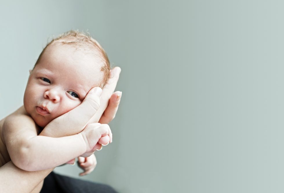 Adult holds infant