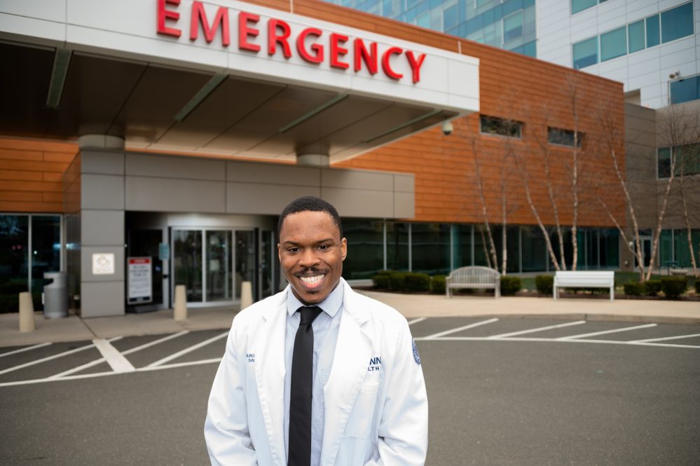 Nurudeen Lucky Osumah '22 MD standing outside the emergency department