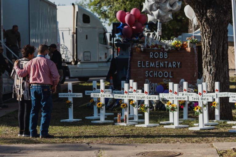 Crosses bearing the names of the victims of a mass shooting in front of Robb Elementary School on May 26, 2022 in Uvalde, Texas. The rural Texas community is in mourning following a shooting at Robb Elementary School which killed 21 people including 19 children.