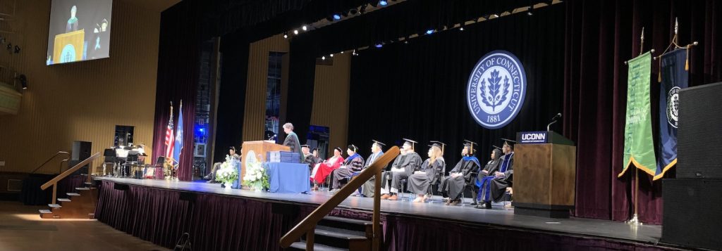 Dr. Deidre Gifford speaks to the PharmD. Class of 2022 from the stage in the Jorgenson Center, Storrs