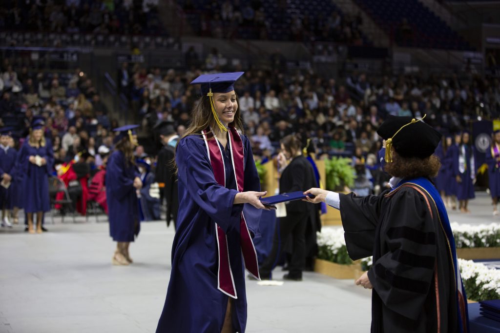 Dean Juli Wade hands a degree to a graduate