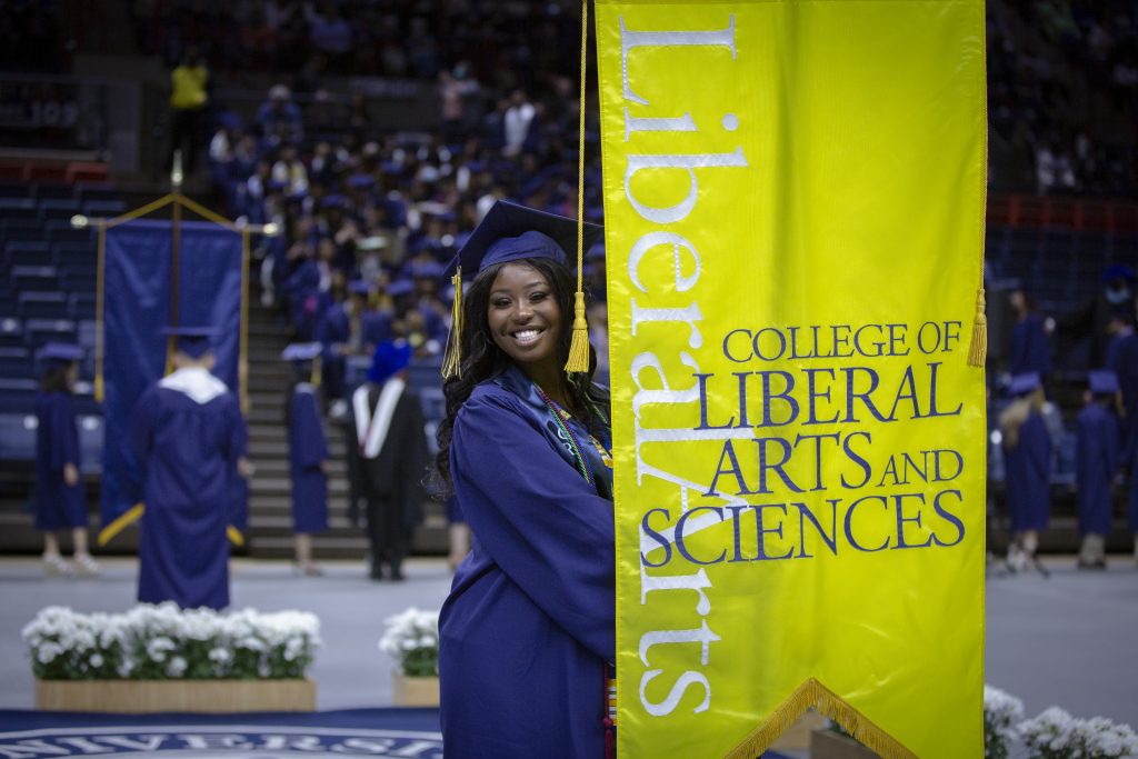 Jaelie Jackson ‘22 (CLAS) carries the College of Liberal Arts and Sciences banner